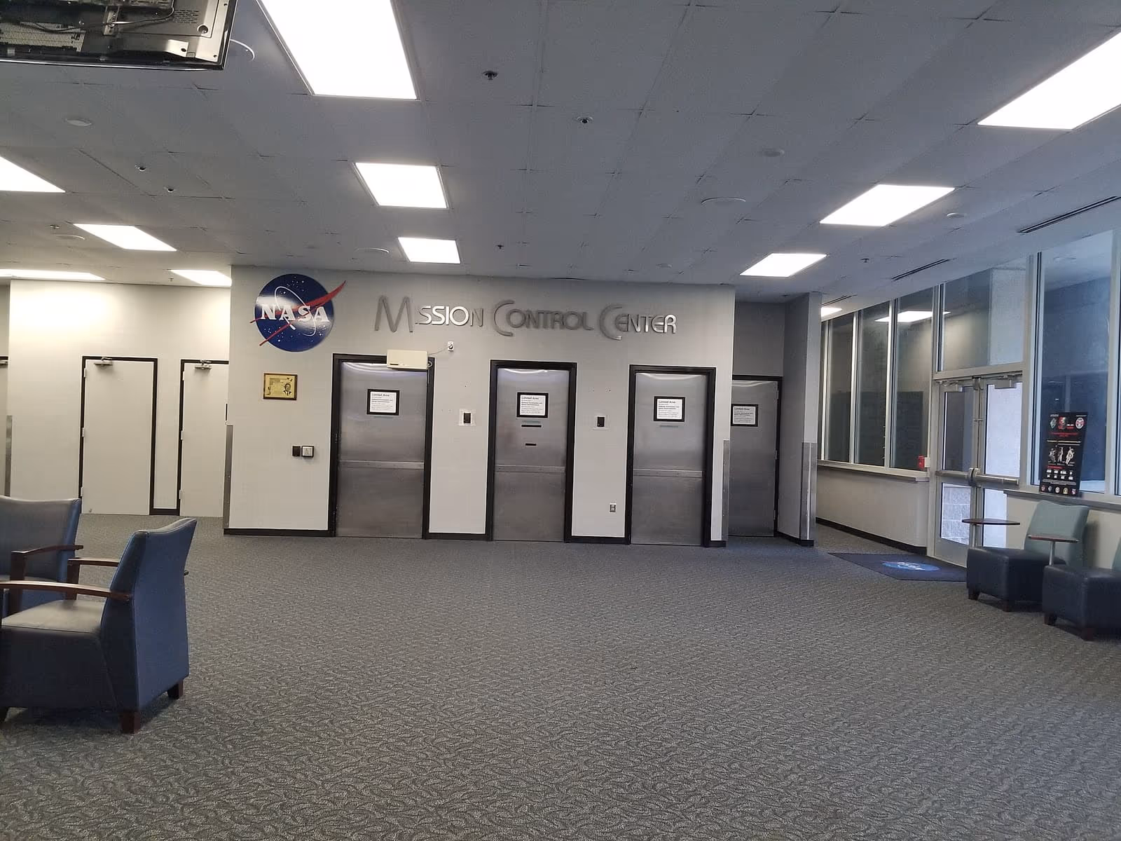 Flight controllers at consoles in a mission control centre